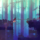 the beheaded uses a hookshot to cross a chasm in a forest in dead cells on xbox game pass